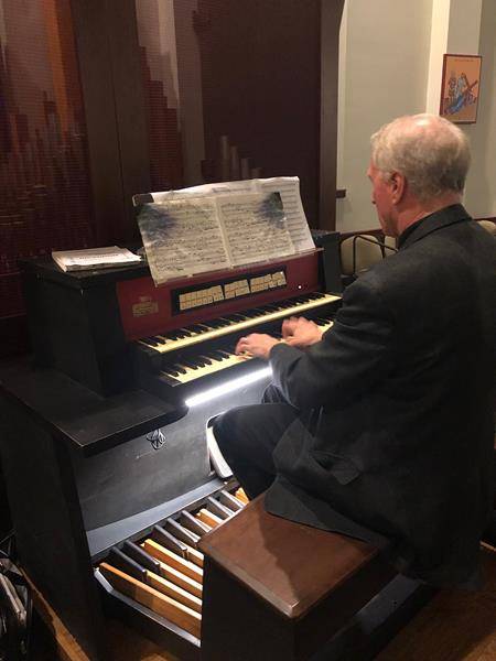 The priests also dedicated and blessed a new organ recently installed in the high school's chapel, shown here being played by Dr. Thomas Savoy.