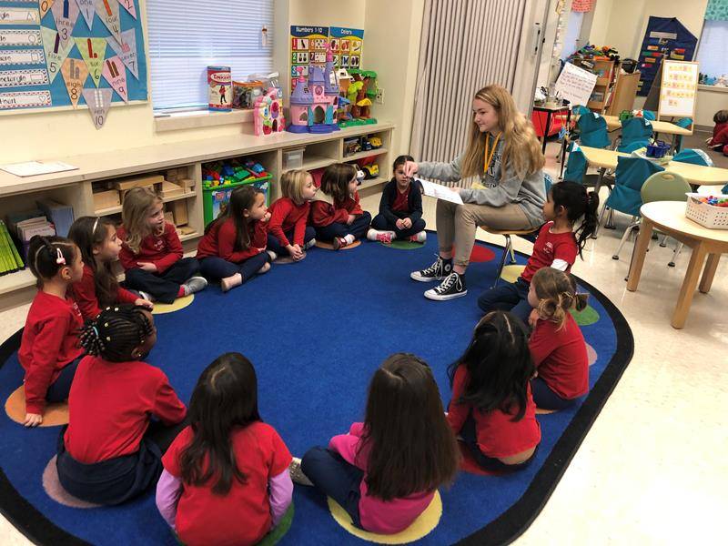 HIGH POINT - Bishop McGuinness High School students read to Immaculate Heart of Mary School Eagle’s Nest Pre-K students. (Photo provided by Carrie Vest)