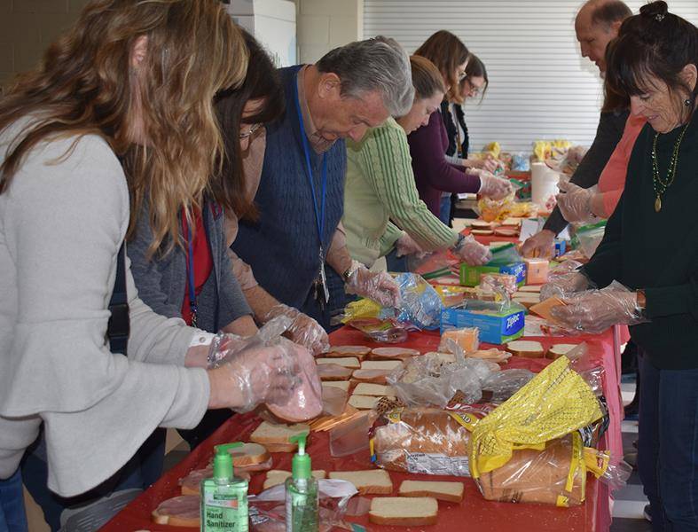 CHARLOTTE — Holy Trinity Middle School teachers made sandwiches for the Urban Ministry Center of Charlotte during Catholic Schools Week. (Photo provided by Lisa Michalski-Gilkey)