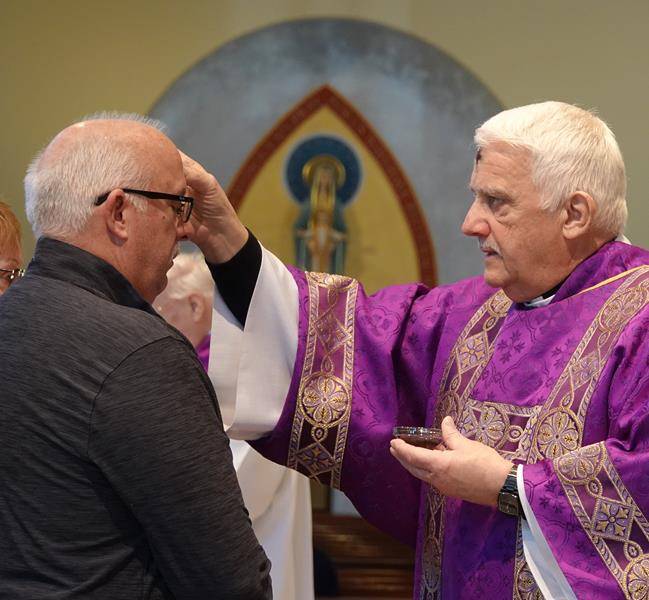 HUNTERSVILLE — Parishioners at St Mark Church in Huntersville received ashes on Ash Wednesday during several liturgies, including this one led by Deacon Louis Pais and assisted by Deacon Ron Sherwood. (Photo provided by Amy Burger)
