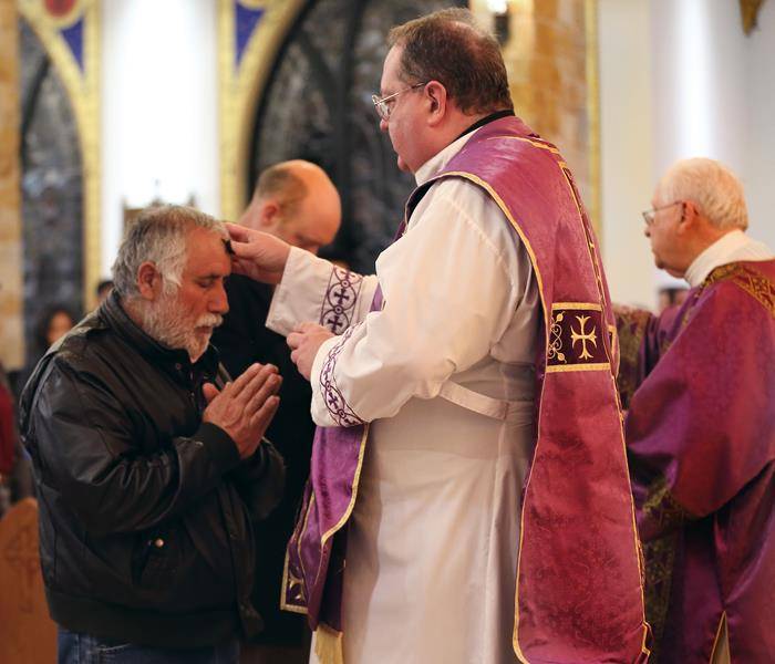 FOREST CITY — Father Herbert Burke and Deacon Andy Cilone distributed ashes at Immaculate Conception Church. (Giuliana Polinari Riley, correspondent)
