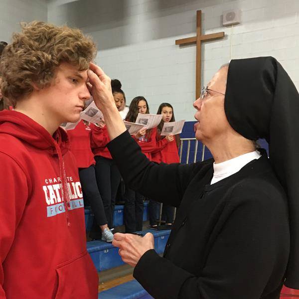 CHARLOTTE —Sophomore Eric Koltz receives ashes from Sister Agnes Cousins, OSF, during Ash Wednesday Mass at Charlotte Catholic High School March 6. (Photo provided by Joann S. Keane)