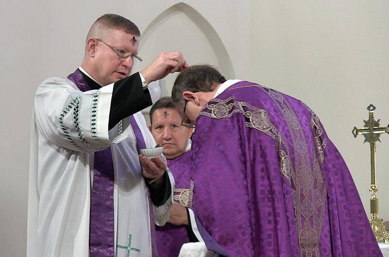 CHARLOTTE — Bishop Peter Jugis and Father Christopher Roux celebrated Mass on Ash Wednesday at St. Patrick Cathedral. Students from St. Patrick School attended. (Photo by César Hurtado)