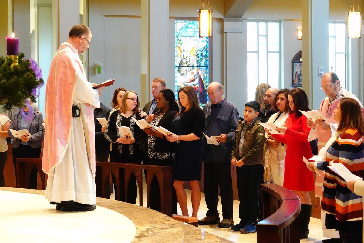 Nineteen catechumen and 14 candidates made their Rite of Acceptance Dec. 15 at St. Mark Church in Huntersville. Father John Putnam, pastor, presided. (Photo by Amy Burger)