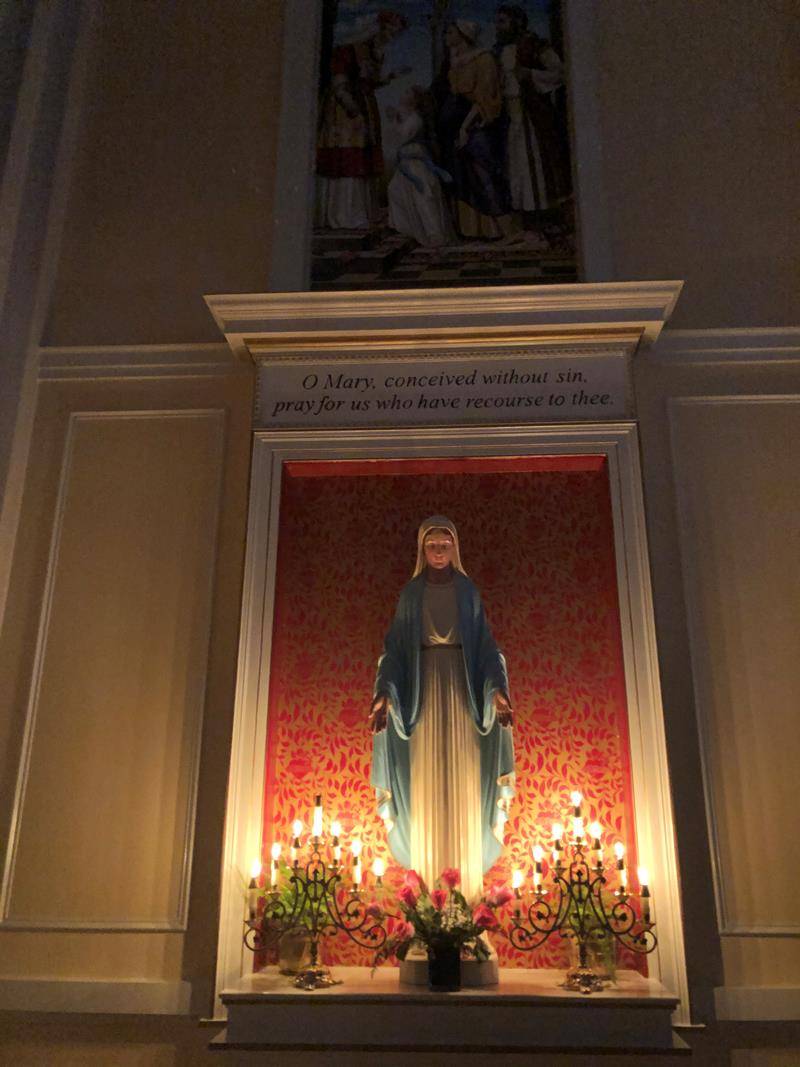 A statue of the Blessed Mother is illuminated for the Rorate Mass held Dec. 14 at St. Ann Church in Charlotte. The Advent Mass in honor of the Blessed Mother in the Extraordinary Form began at 6:30 a.m. and culminated just after sunrise. (SueAnn Howell )