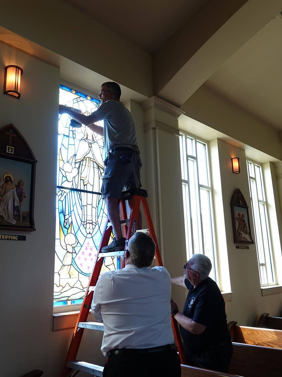 St. Mark Assumption window K of C help install window they donated.